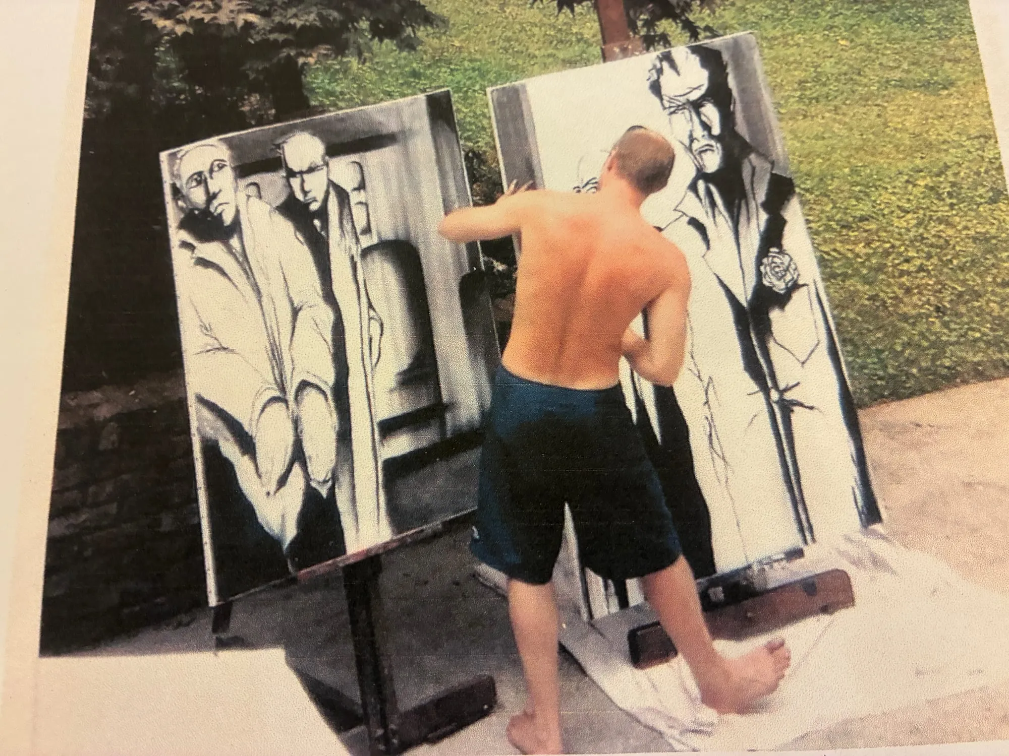 Jonathan Roy painting large black-and-white canvases outdoors